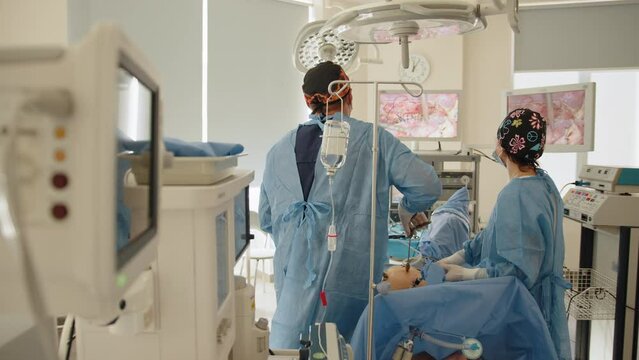 Team surgeon at work on laparoscopy operating in hospital. Surgeon performing operation. The surgeon's doing laparoscopic surgery in the operating room. Minimally invasive surgery.