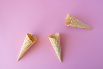 Creative photo of empty waffle cones on a pink background.
