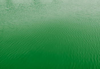 A 3D rendering of a green abstract water surface background
