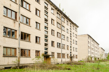 Abandoned white brick multistorey houses. Forgotten, abandoned ghost town Skrunda, Latvia. Former Soviet army radar station.