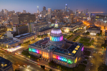 San Francisco’s city hall, decked out in rainbow lights for pride, with the skyline in the background. California, USA