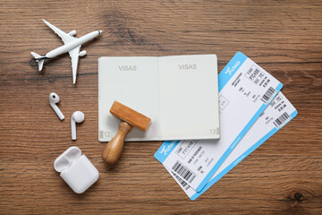 Flat lay composition with passport, stamp and flight tickets on wooden table