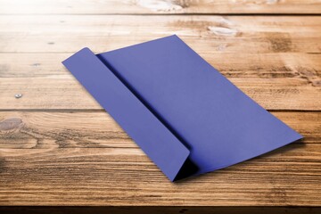 Navy violet envelope on desk. Kraft paper with subtle fibers.