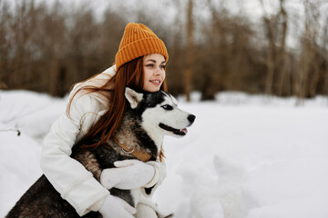 portrait of a woman outdoors in a field in winter walking with a dog winter holidays