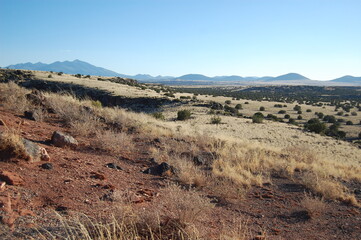 The vast desert landscape of the Colorado Plateau, with the San Francisco Peaks, Mount Humphreys in the background, Wupatki National Monument, Coconino County, Flagstaff, Arizona.