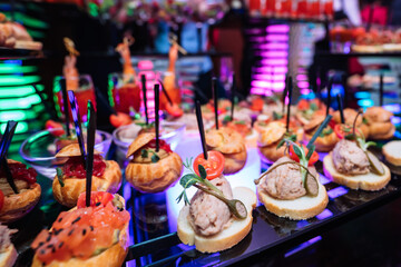 Decorated catering banquet table with different food snacks and appetizers with sandwich