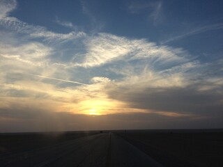 Fototapeta na wymiar road and clouds horizon sunset