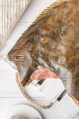 raw flounder on a light board