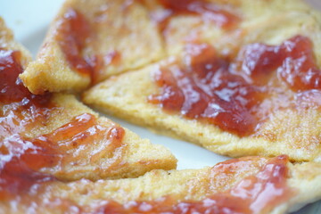 Food in shape of a French toast with Marmelade or strawberry jam