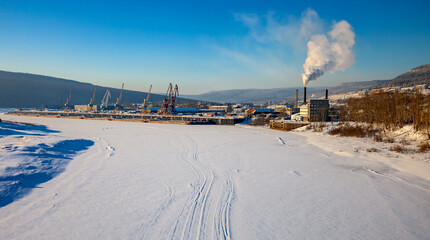 Floodplain of the Lena River and the city of Ust-Kut on frosty winter day.