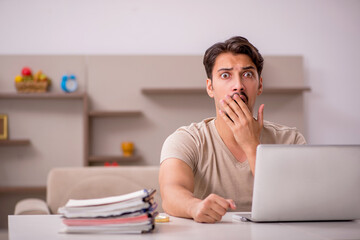 Young male employee working from house
