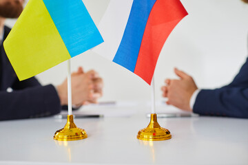 Close up of Russian and Ukrainian flags. Diplomats negotiate on war between Russia and Ukraine....