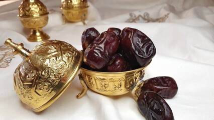 Ramadan food, moroccan traditions, dry dates in a traditional golden plate