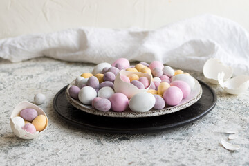 Easter composition with mini chocolate eggs in pastel colors