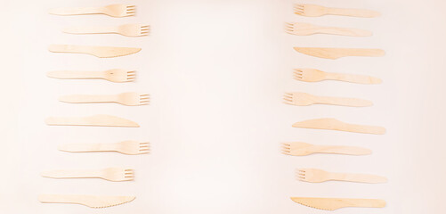 Disposable wooden cutlery.Eco concept.Banner eco friendly disposable kitchenware utensils on white background.Wooden forks,spoons,zero waste.Copy space.Eco friendly wooden cutlery.plastic free concept