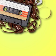 Old vintage retro audio cassette tape with magnetic tape has unravelled