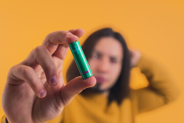 Close-up shot of a battery held by caucasian man. Recycling and energy concept. . High quality photo