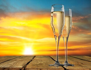 Two Champagne glass on ocean at summer sunset. Tropical travel vacation trip concept