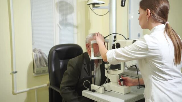 ophthalmologist examination of elderly man with slit lamp. medical equipment