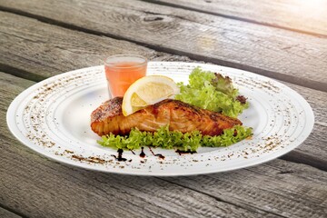 Fried salmon with vegetableson plate. Sprinkled with sesame seeds.