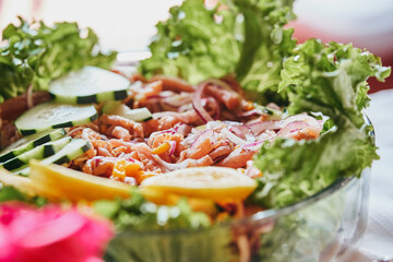 Traditionally made Mexican ceviche. Fish strips with tomato, lettuce, onion, avocado, orange.