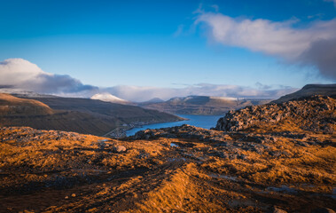Small village Oyggjarvegur situated on the slope of the mountain on Streymoy island. Faroe Islands, Denmark. November 2021