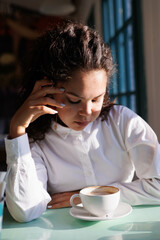 serious curly girl portrait with great sun light. Woman closeup. asian caucasian pretty young woman eyes and lips