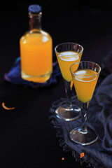 Orange liqueur in glasses on a navy blue background,  Italian alcoholic drink