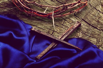 Holy Week concepts. Wooden cross in blue vintage ribbon