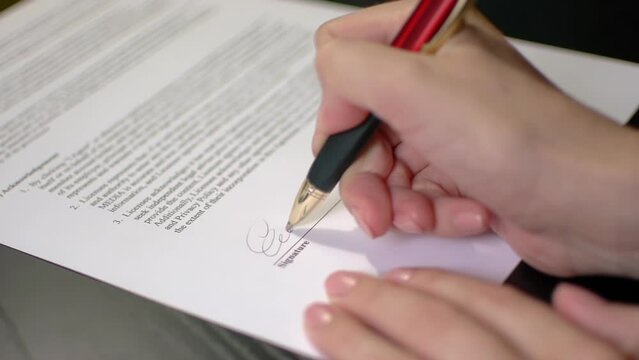 Woman signing an official document
