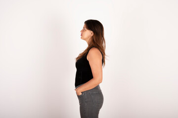 Portrait of a young latin woman in profile on white background