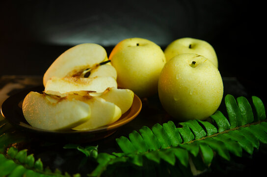 photo of three fresh pears on a black background