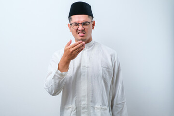 Naklejka premium Asian muslim man having bad breath problem during fasting in ramadan moth