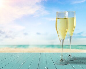 Two Champagne glass on ocean at summer sunset. Tropical travel vacation trip concept
