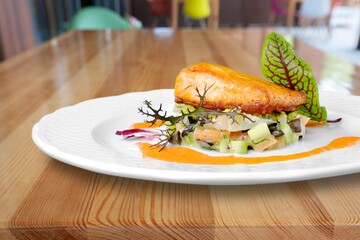 Fried salmon with vegetableson plate. Sprinkled with sesame seeds.