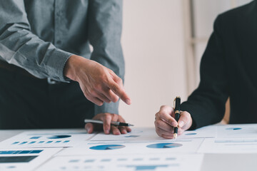 Close up view of two businessman consulting on their project with digital tablet and document file on white table