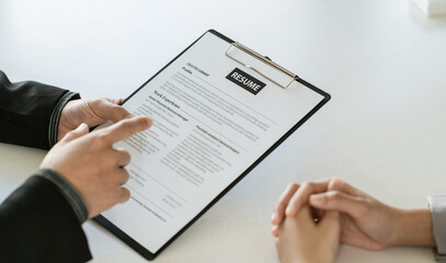 Close up businessman hands holding pen with document at meeting. Man making decision on business...