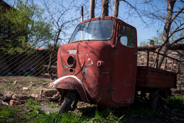 three-wheeled pickup truck left to rot 