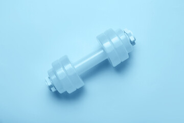 Dumbbell on blue background, top view