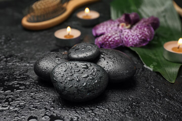 Fototapeta na wymiar Wet spa stones on black background