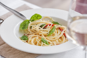 Plate with tasty spaghetti on table, closeup