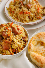 Tasty Asian pilaf and flatbread on table
