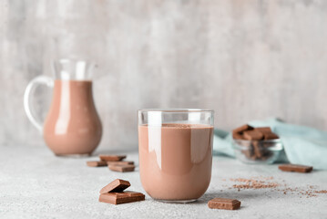 Glass of delicious chocolate milk on grunge background