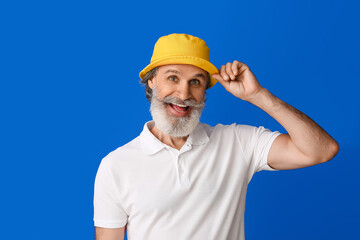 Stylish mature man on color background