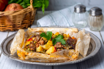 Traditional Turkish food; Meat with vegetables wrapped in greaseproof paper, kebab (Turkish name; Sebzeli kagit kebabi)