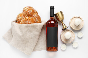 Traditional challah bread with wine and candles on white background. Shabbat Shalom - obrazy, fototapety, plakaty