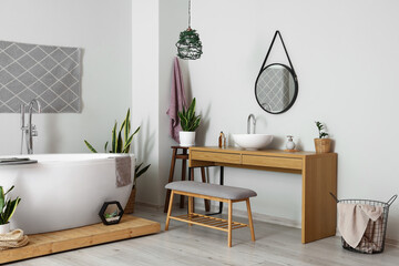 Interior of light bathroom with sink, mirror and bench