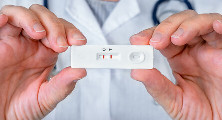 The doctor holds positive express test