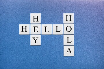 Hey Hola Hello letters, tiles against blue background. © BillionPhotos.com
