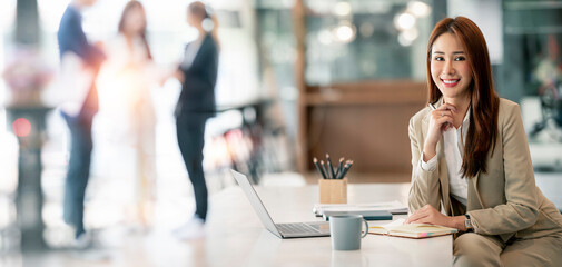 Confident Businesswoman Smiling At Camera Sitting In Modern Office.